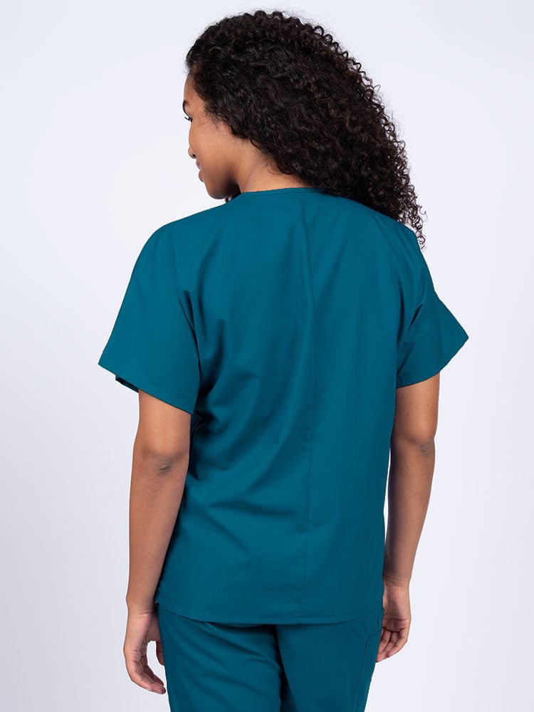 Nurse wearing a Luv Scrubs Unisex Single Pocket V-Neck Scrub Top in Caribbean with a center back length of 27.5".