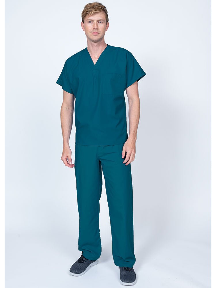Young man wearing a Luv Scrubs Single Pocket V-Neck Scrub Top in Caribbean featuring a unisex fit.