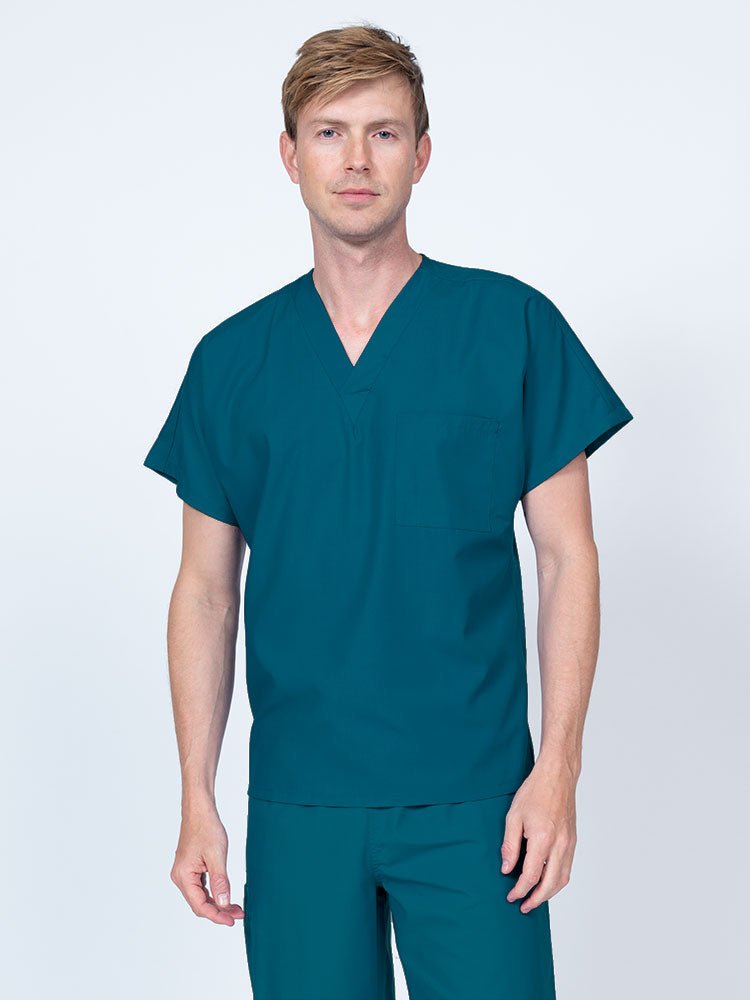 Man wearing a Luv Scrubs Unisex Single Pocket V-Neck Scrub Top in Caribbean with dolman sleeves and 1 chest pocket.