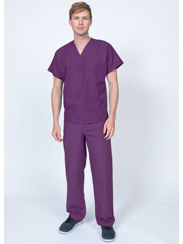 A young male Home Health Aide wearing a Luv Scrubs Single Pocket V-Neck Scrub Top in Eggplant featuring a unisex fit.