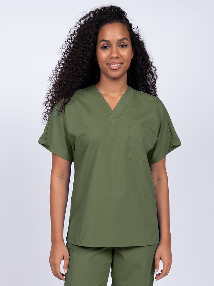 Young woman wearing a Luv Scrubs Unisex Single Pocket Scrub Top in olive featuring a V-neckline.