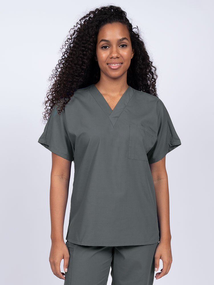 Young woman wearing a Luv Scrubs Unisex Single Pocket Scrub Top in pewter featuring a V-neckline.