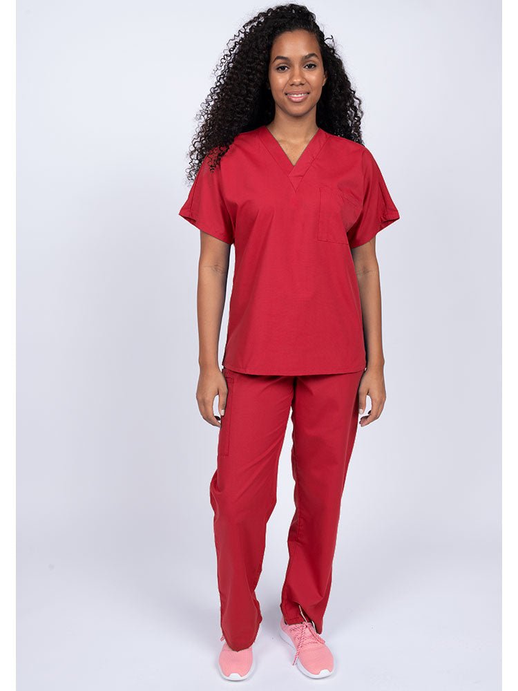 Young woman wearing a Luv Scrubs Unisex Single Pocket Scrub Top in red featuring a V-neckline.