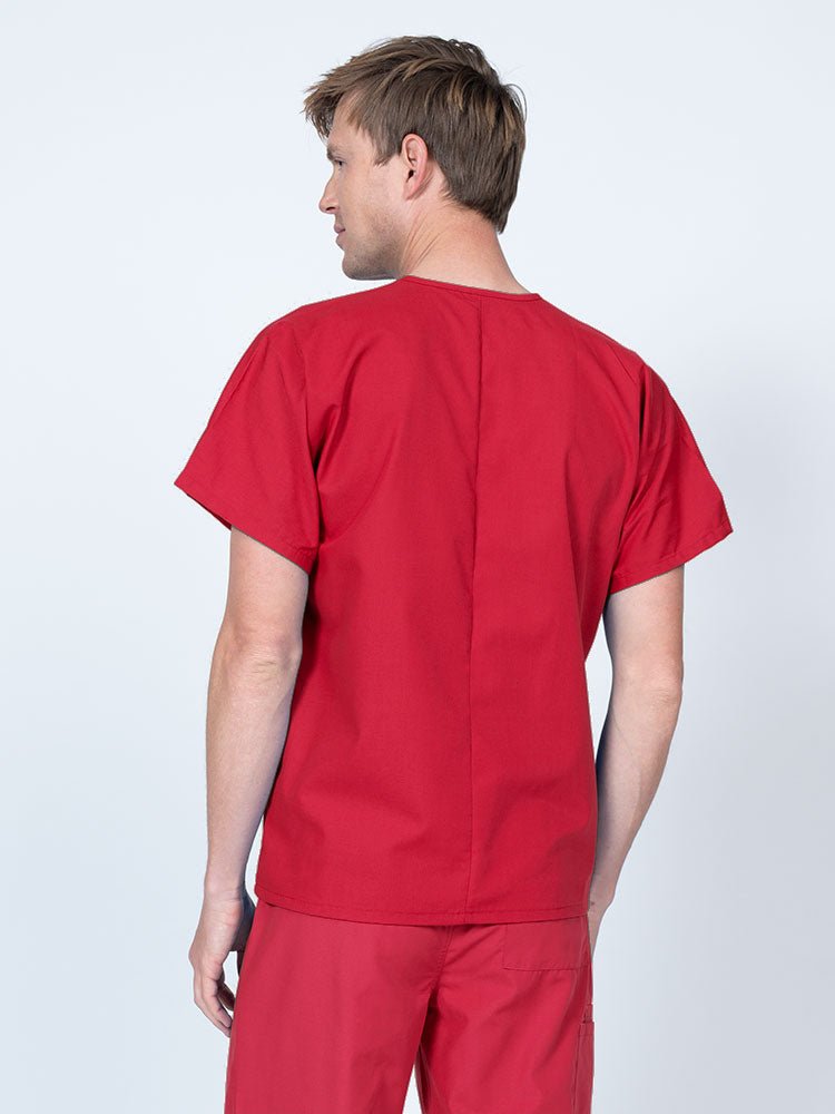 Male nurse wearing a Luv Scrubs Unisex Single Pocket V-Neck Scrub Top in red with a lightweight, breathable fabric made of 55% Cotton and 45% Polyester.
