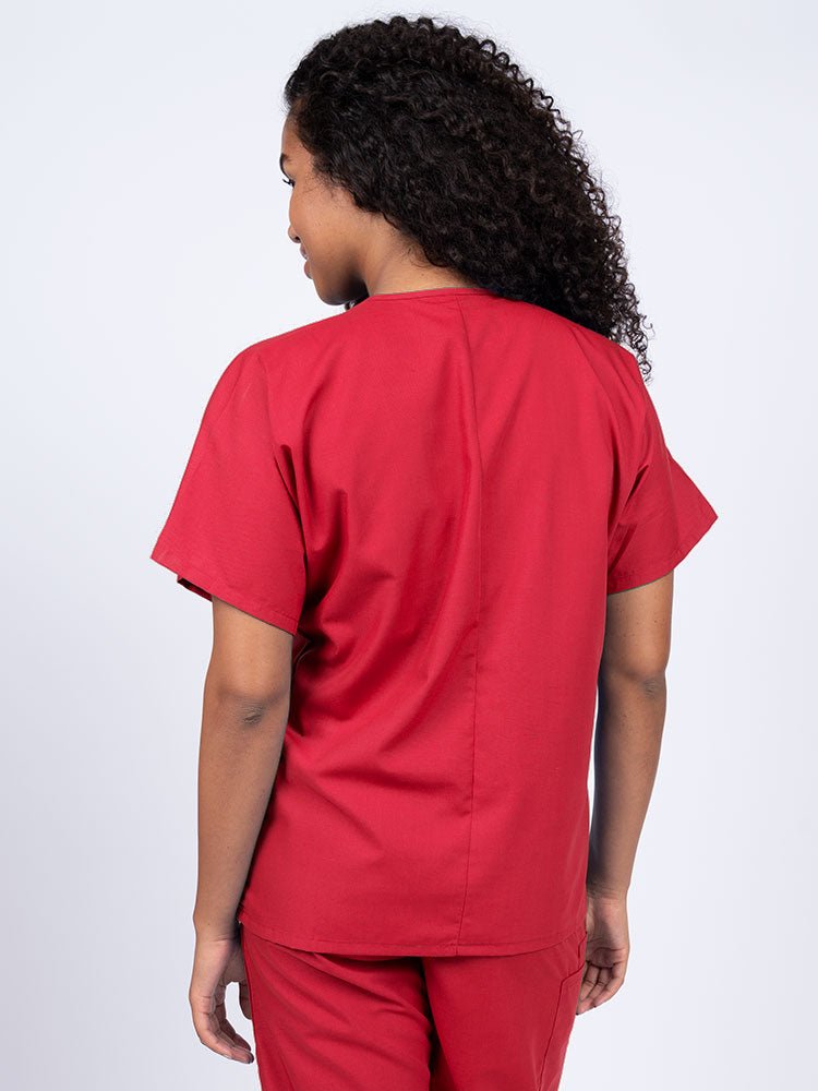 Nurse wearing a Luv Scrubs Unisex Single Pocket V-Neck Scrub Top in red with a center back length of 27.5".
