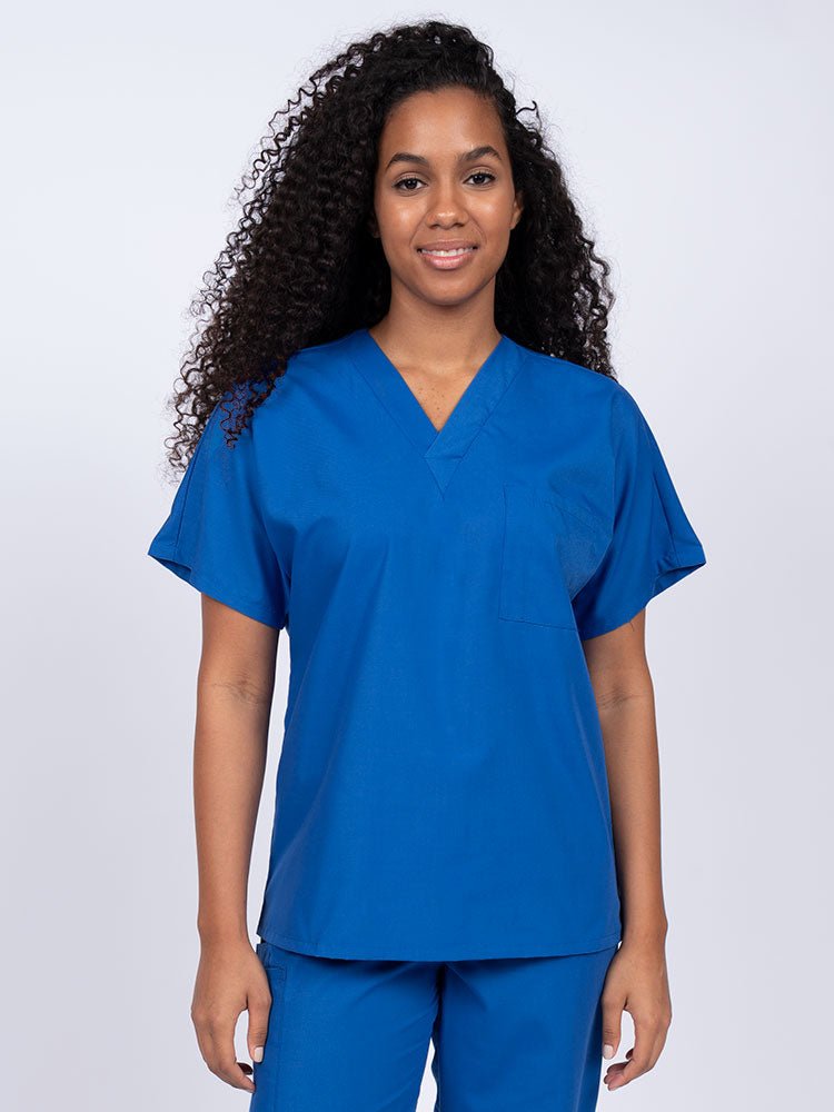 Young woman wearing a Luv Scrubs Unisex Single Pocket Scrub Top in royal featuring a V-neckline.