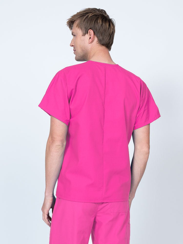 Male LPN wearing a Luv Scrubs Unisex Single Pocket V-Neck Scrub Top in shocking pink with a lightweight, breathable fabric made of 55% Cotton and 45% Polyester.