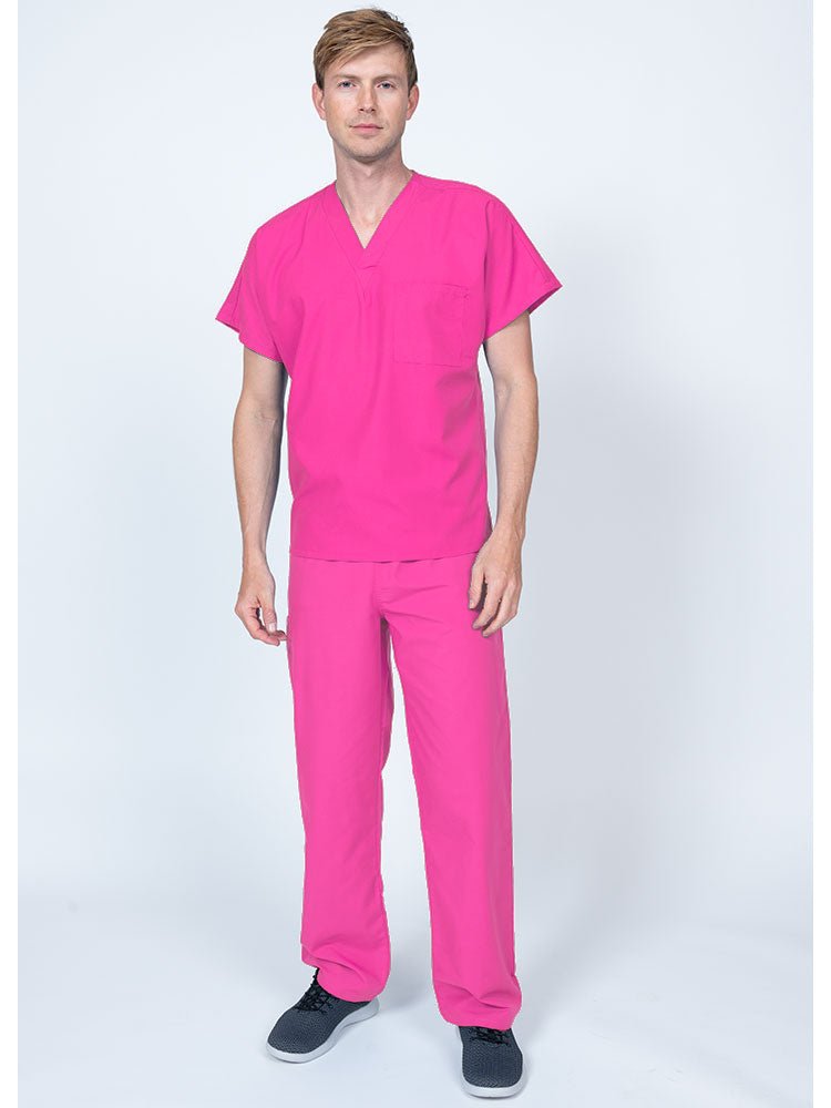 A young male Home Health Aide wearing a Luv Scrubs Single Pocket V-Neck Scrub Top in shocking pink featuring a unisex fit.