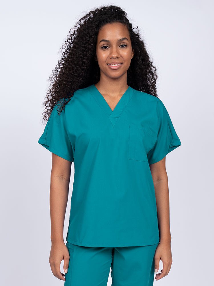Young woman wearing a Luv Scrubs Unisex Single Pocket Scrub Top in teal featuring a V-neckline.