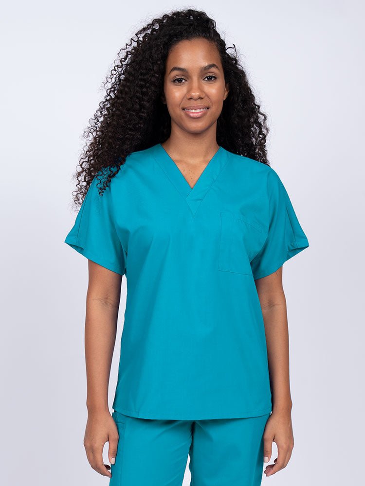 Young woman wearing a Luv Scrubs Unisex Single Pocket Scrub Top in turquoise featuring a V-neckline.