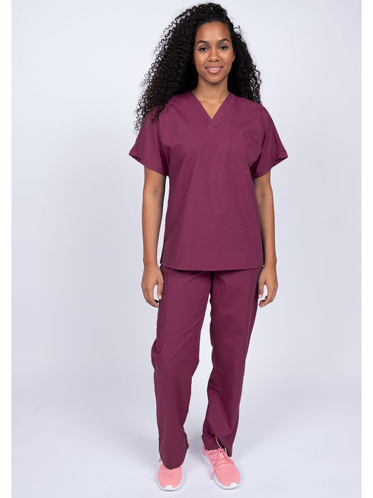 Young woman wearing a Luv Scrubs Unisex Single Pocket Scrub Top in wine featuring a V-neckline.