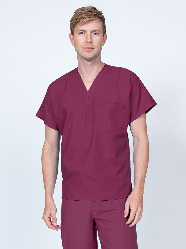 Man wearing a Luv Scrubs Unisex Single Pocket V-Neck Scrub Top in wine with dolman sleeves and 1 chest pocket.