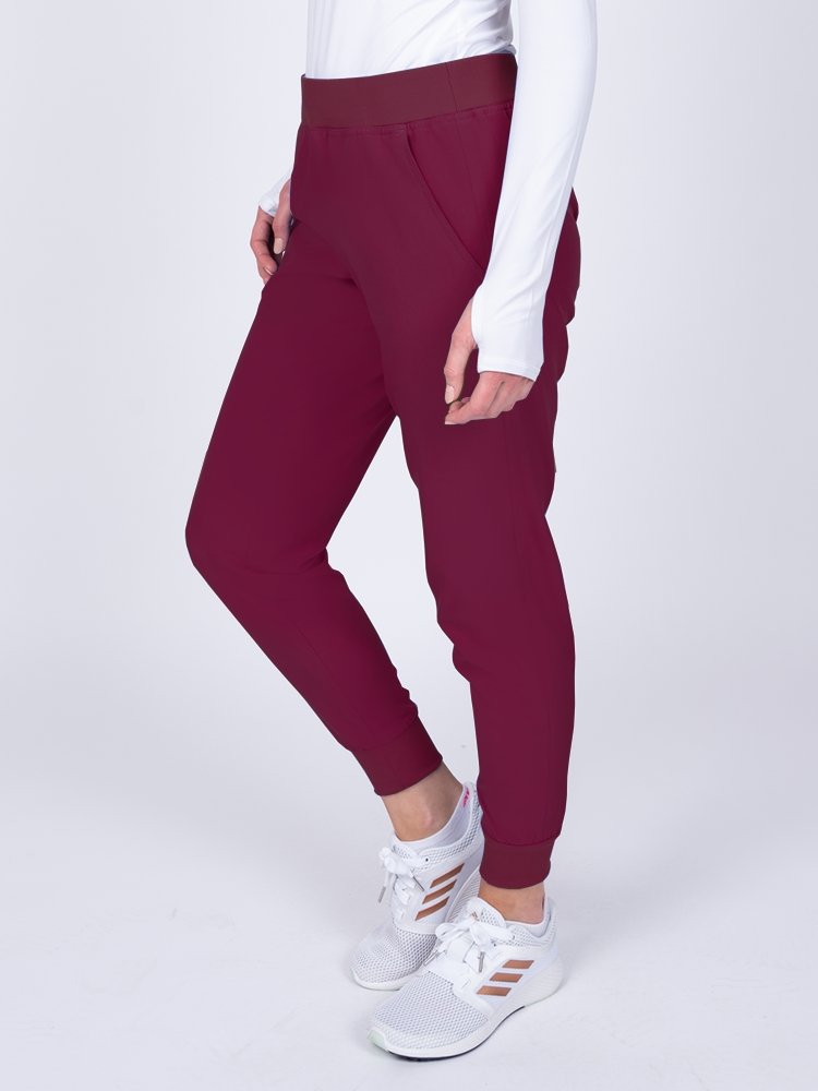 Meraki Sport Women's Jogger Scrub Pant in wine featuring 5% spandex for added stretch