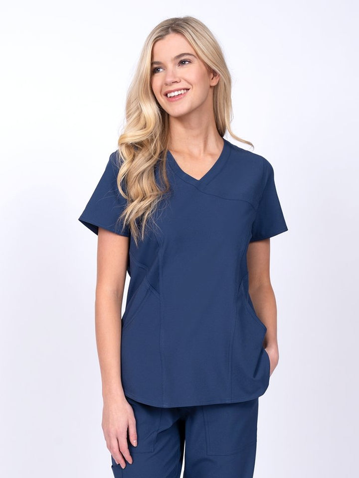 Meraki Sport Women's Mock Wrap Scrub Top in navy featuring front princess seams to provide a flattering fit