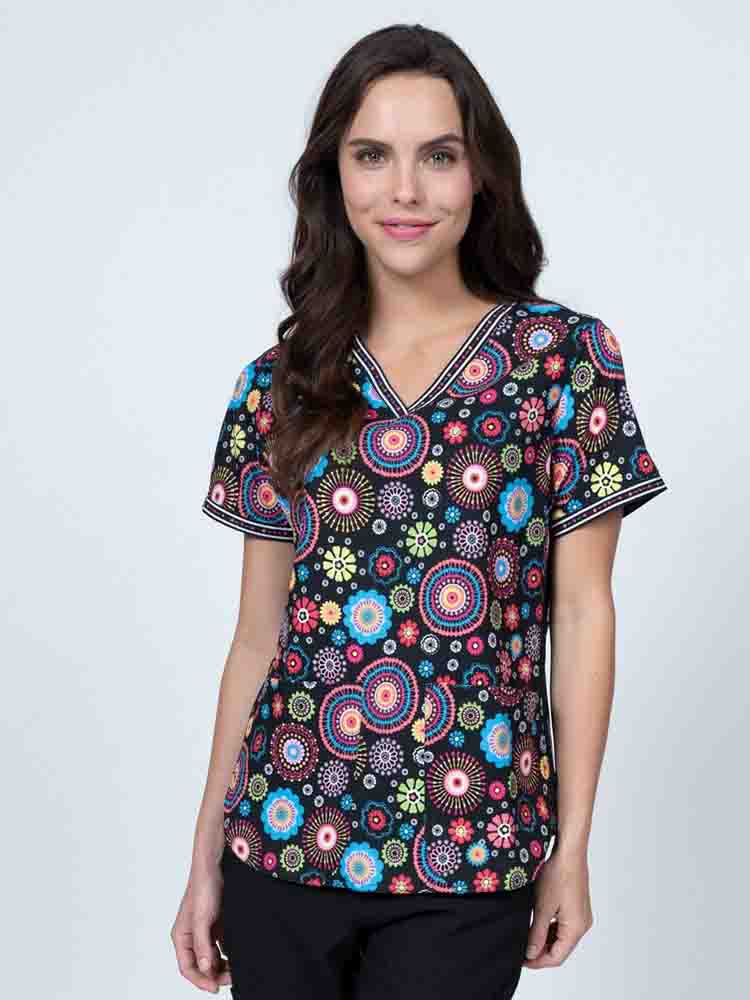 Young healthcare professional wearing a Meraki Sport Women's Print Scrub Top in "Cute n Cool" featuring stretch side panels for a comfortable all day fit.