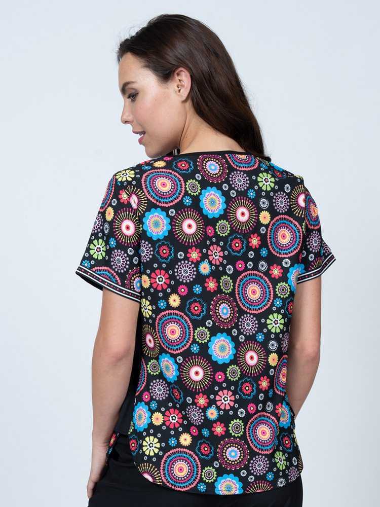 Young nurse wearing a Women's Print Scrub Top in "Cute n Cool" from Meraki Sport featuring shoulder yokes for a flattering fit.