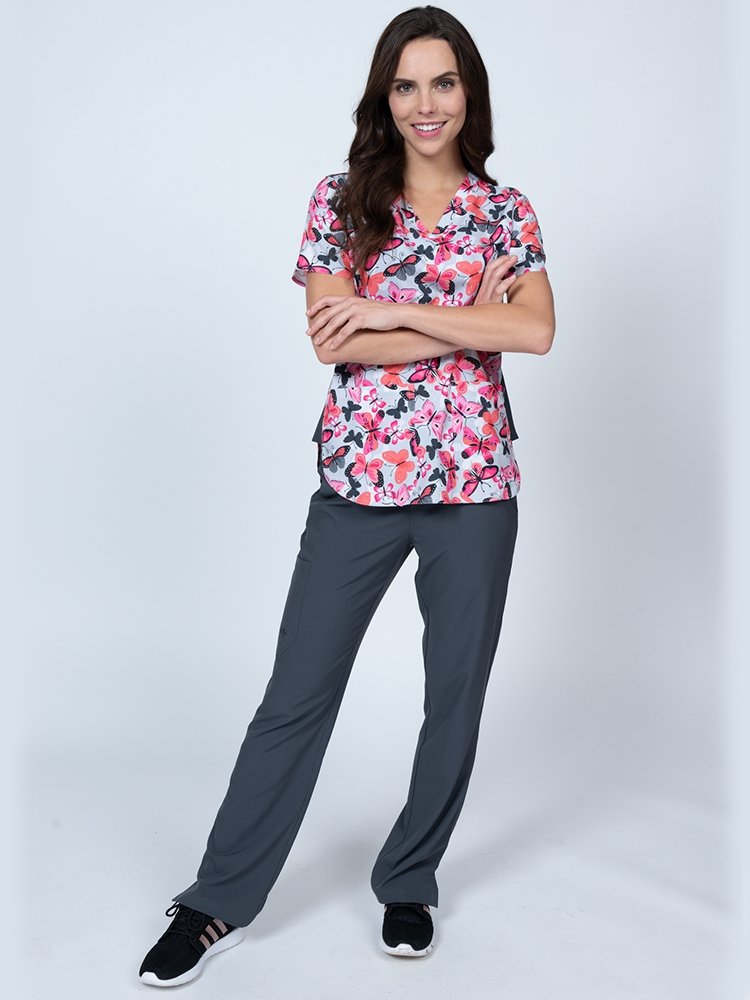 RN wearing Meraki Sport Women's Print Scrub Top in Enchanted Spirit print size extra small