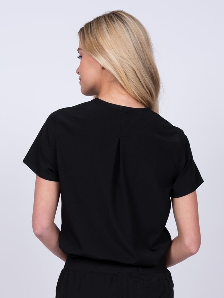 Meraki Sport Women’s Tuck-In Scrub Top in black featuring Back inverted pleat