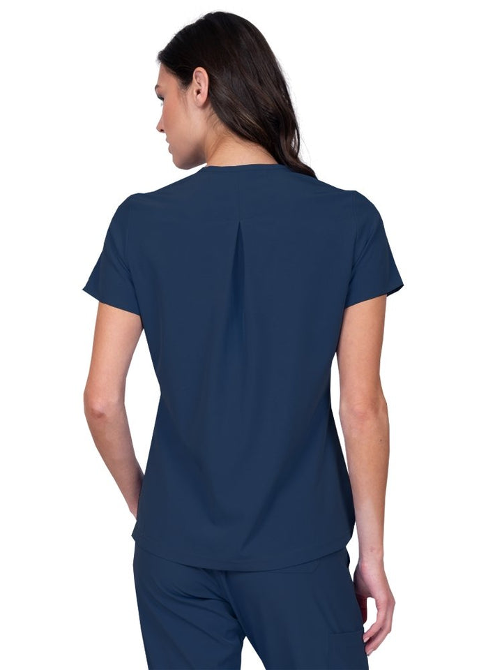 Meraki Sport Women’s Tuck-In Scrub Top in navy featuring  a slight high low curved hemline