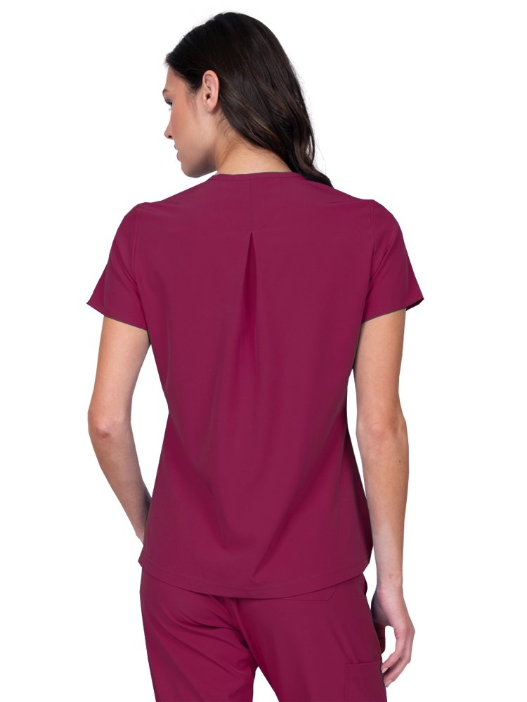 Meraki Sport Women’s Tuck-In Scrub Top in wine featuring  a slight high low curved hemline