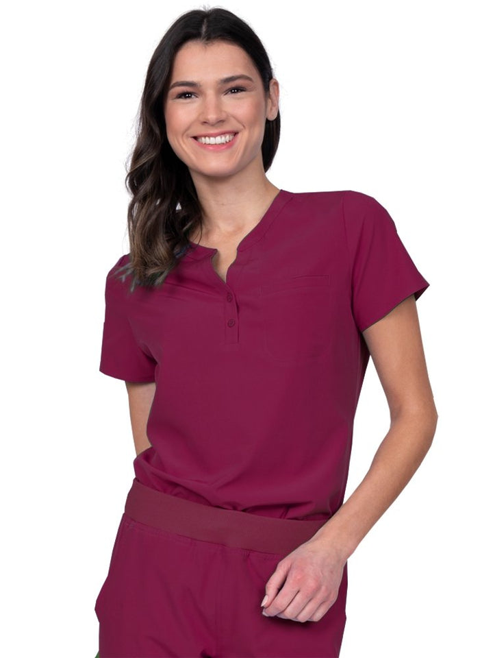 Meraki Sport Women’s Tuck-In Scrub Top in wine featuring a Henley neckline with 2-button placket