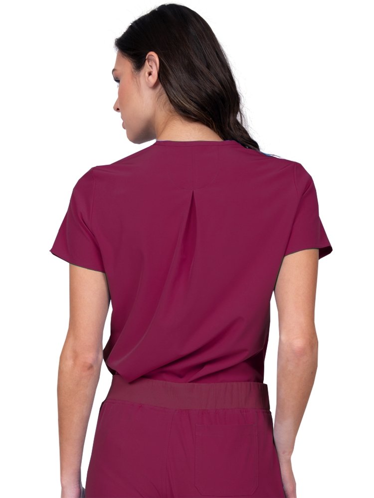 Meraki Sport Women’s Tuck-In Scrub Top in wine featuring Back inverted pleat