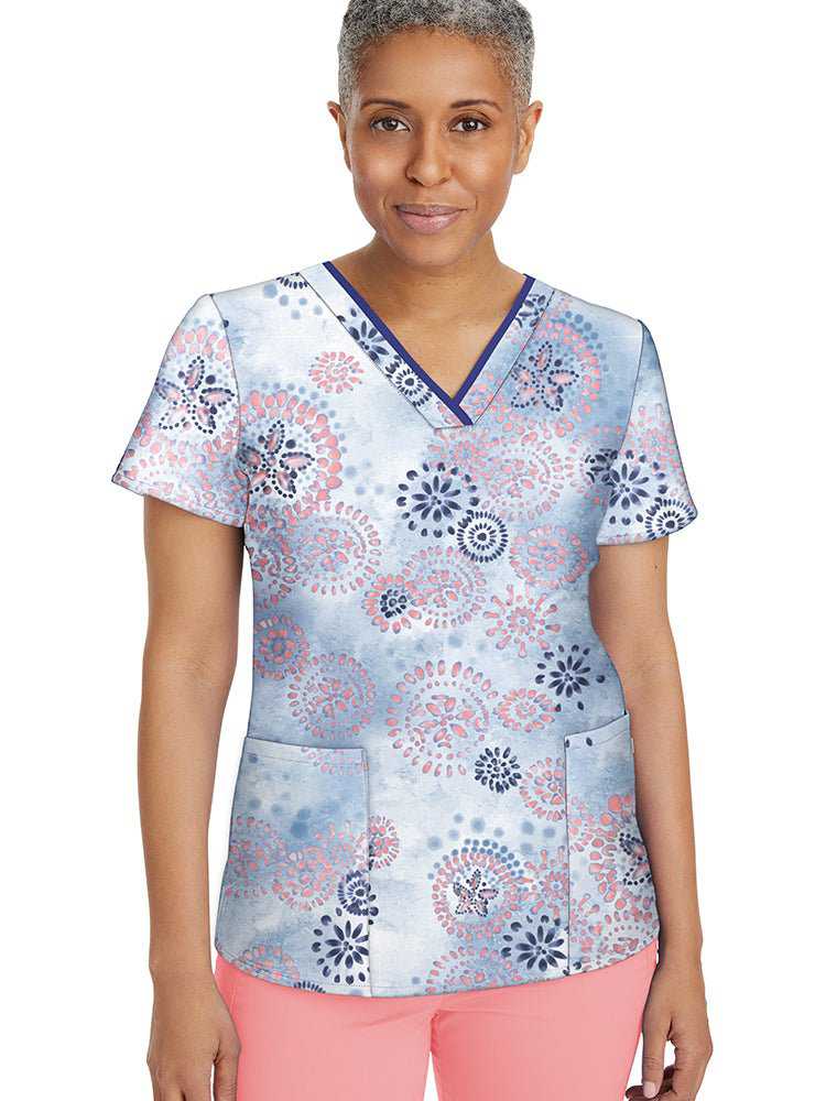 Female nurse wearing a Women's Amanda Print Top from Healing Hands featuring a V-neckline and 2 front welted pockets.