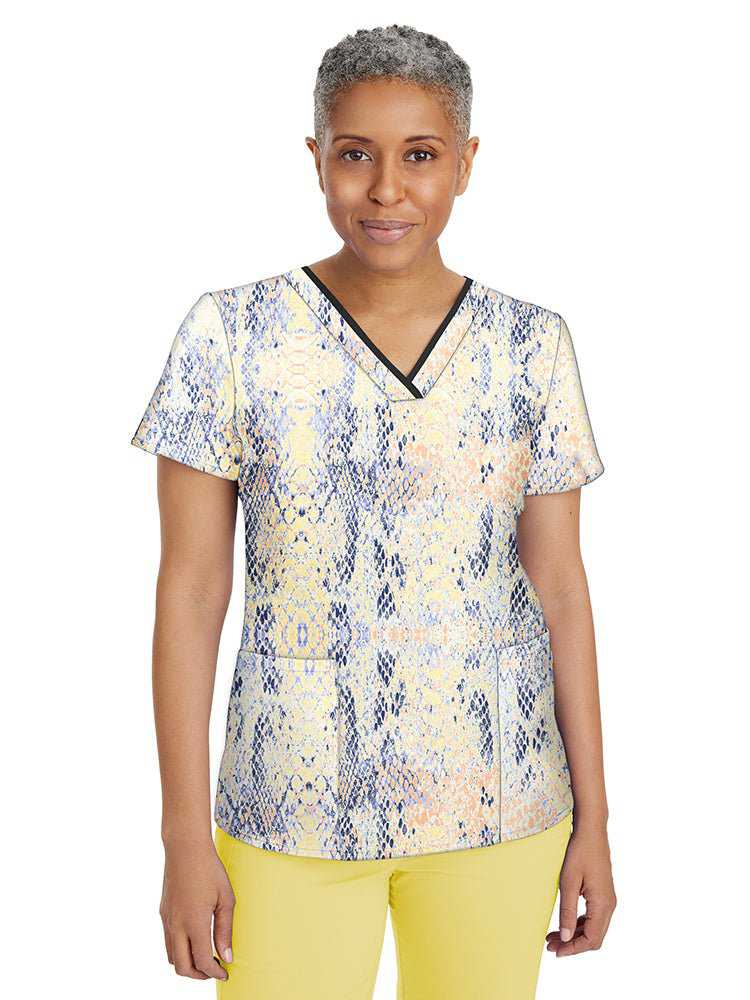 Female nurse wearing a Women's Amanda Print Top from Premiere by Healing Hands in "Summer Skin" featuring 2 front welted pockets & an additional interior pocket.