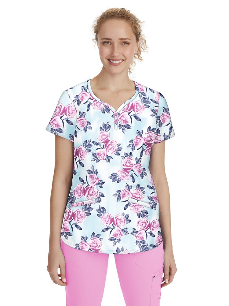 Nurse wearing a Women's Isabel Print Top from Premiere by Healing Hands in "Scent of a Rose" featuring bust & back darts for a flattering fit.