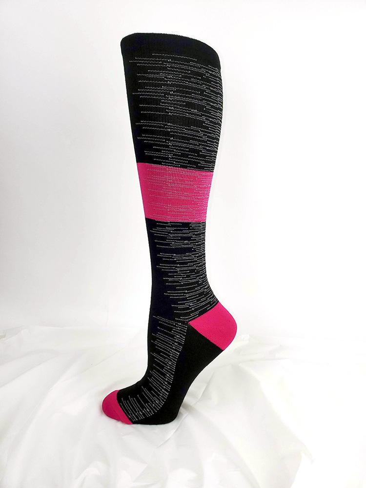 Foot mannequin displaying Pro-Motion Women's Compression Socks in black with pink and white stripes