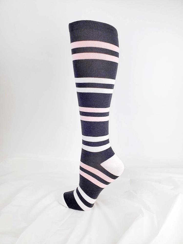 Foot mannequin displaying Pro-Motion Women's Compression Socks in grey with pink & white stripes