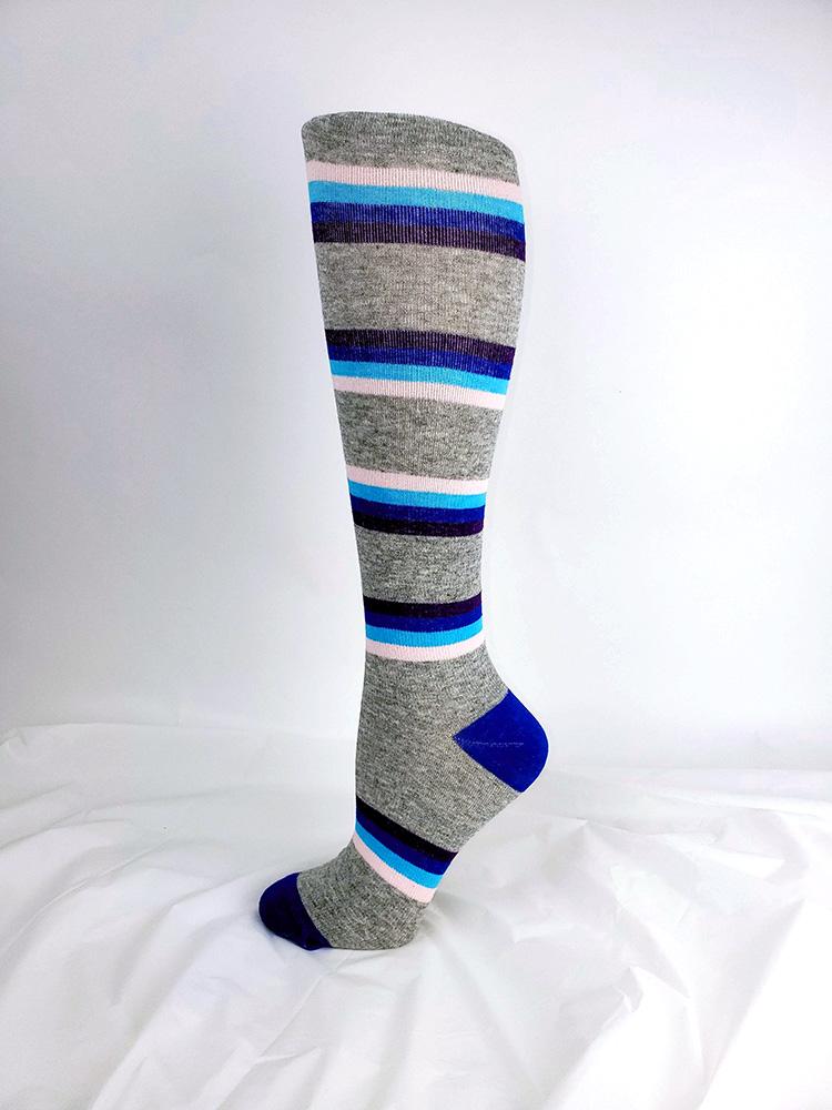 Foot mannequin displaying Pro-Motion Women's Compression Socks in heather grey with multi color stripes
