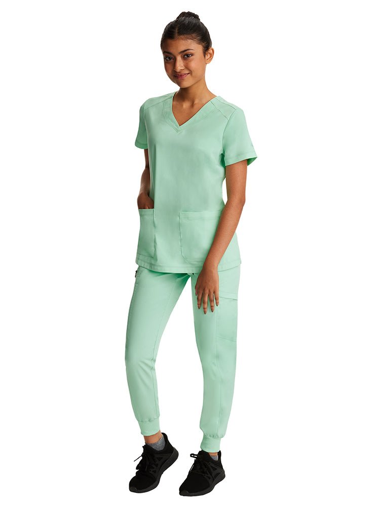 Young nurse wearing a pair of Purple Label by Healing Hands Women's Toby Joggers in Cool Mint with rib knit ankle cuffs.