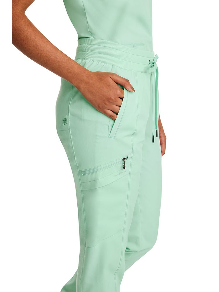 Young nurse wearing a Purple Label by Healing Hands Women's Toby Jogger in Cool Mint featuring a total of 6 pockets.