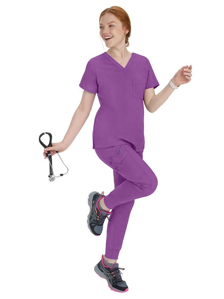 Nurse wearing Purple Label by Healing Hands Women's Toby Jogger in Crush Berry featuring spandex for stretch and comfort