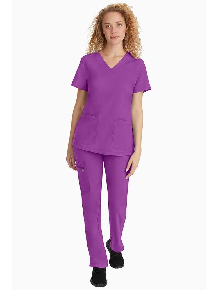Vet Tech wearing Purple Label Women's Jill V-Neck Scrub Top in Crush Berry size medium