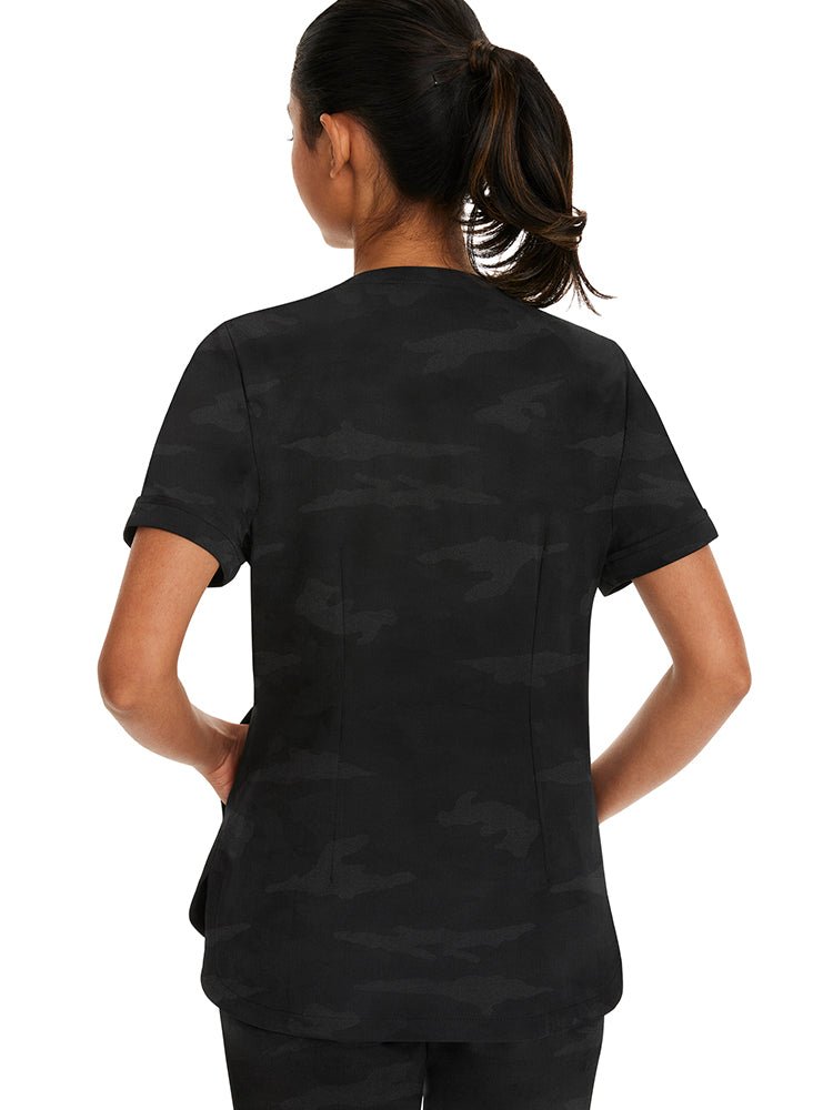 Young woman wearing a Purple Label Women's Joy Camo Top in black with folded cuffs at the end of each sleeve.