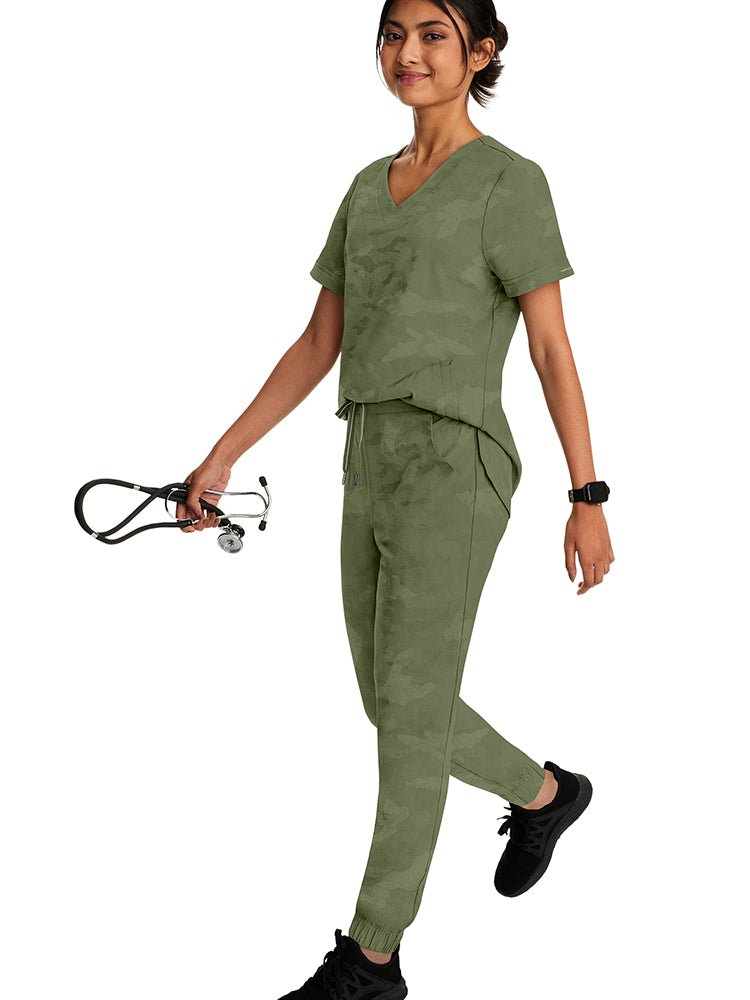 Female healthcare professional wearing a Purple Label Women's Joy Camo Top in Royal featuring a super soft, blend of stretch fabric that is quick drying.
