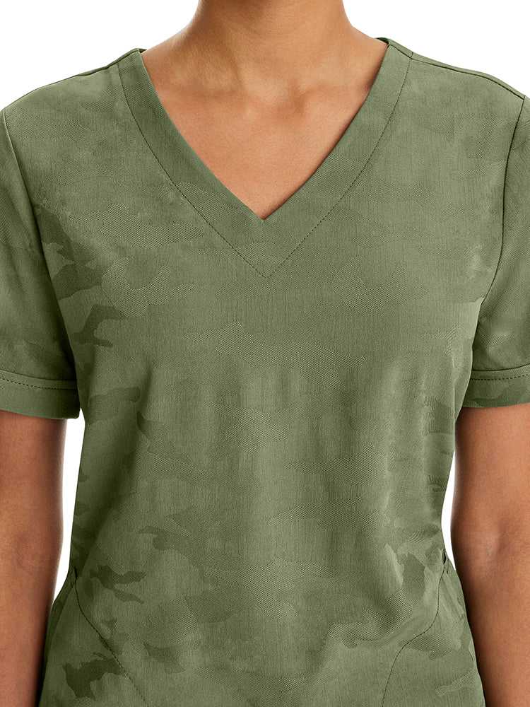Female healthcare professional wearing a Purple Label Women's Joy Camo Top in Olive featuring a unique Jacquard 4-Way Stretch Fabric.
