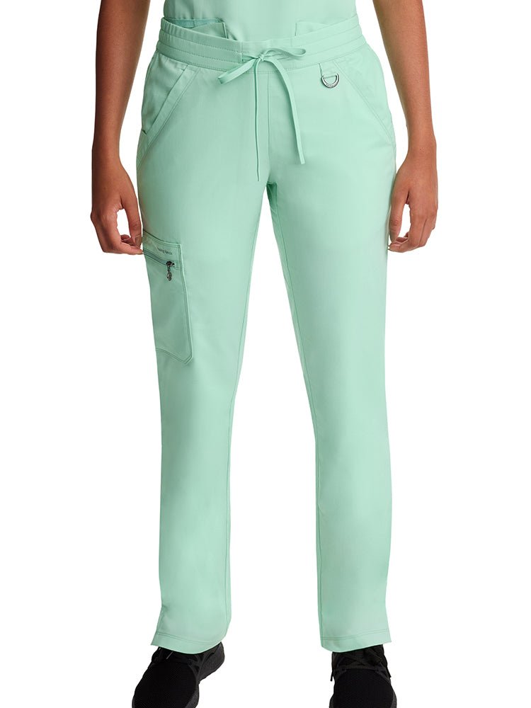 Young woman wearing a Purple Label Women's Tamara Cargo Scrub Pant in "Cool Mint"  with an elastic waistband with drawstring. 