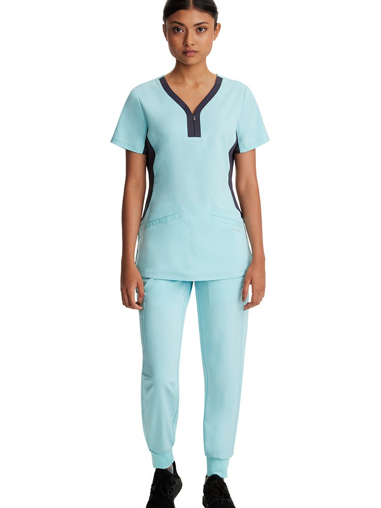 Young nurse wearing a pair of Purple Label Women's Tara Jogger Scrub Pants in "Seabrook" featuring a rib knit trim at the hemline.
