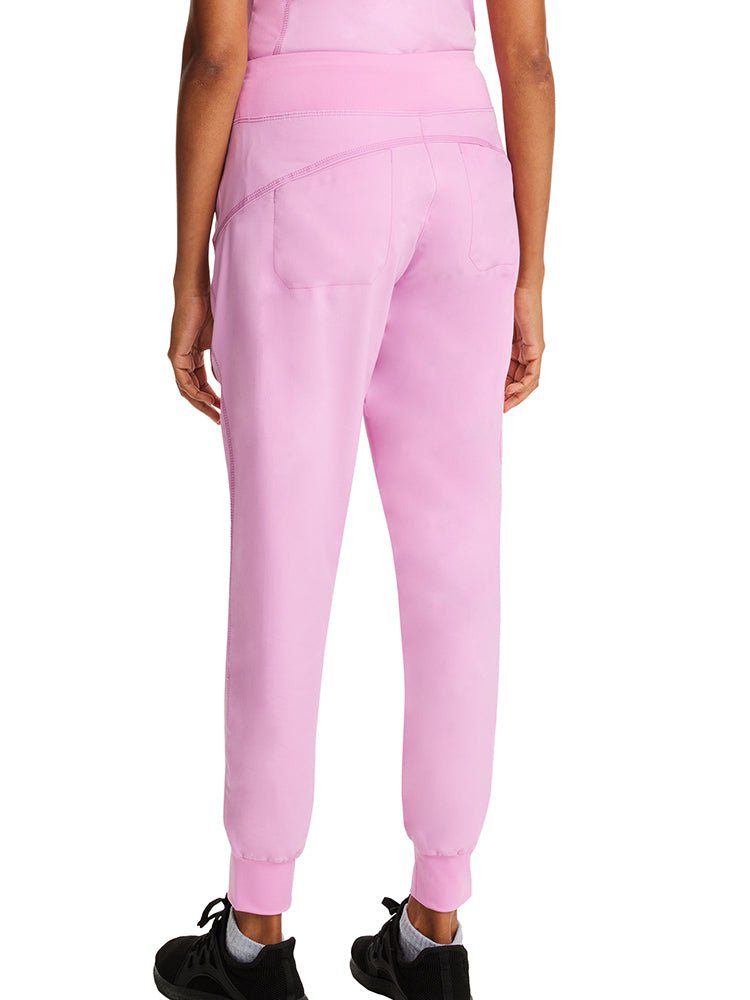 Woman wearing a pair of Purple Label Women's Tara Jogger Scrub Pants in Taffy Pink featuring a knit waistband. 