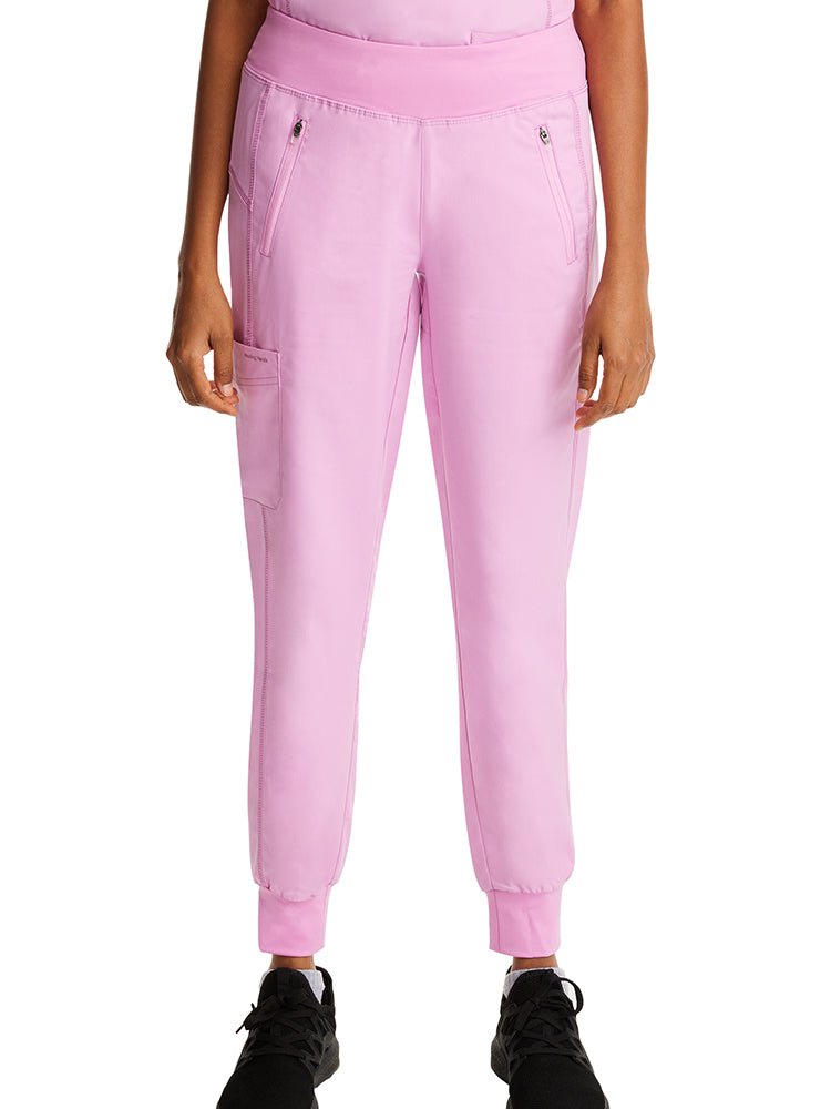 Young woman wearing a pair of Purple Label Women's Tara Jogger Scrub Pants in "Taffy Pink" featuring a modern fit.