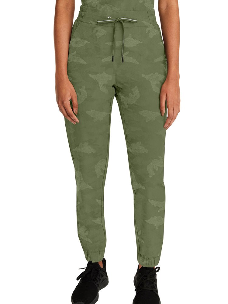 Young woman wearing a pair of Purple Label Women's Tate Camo Joggers in Olive featuring a modern fit.