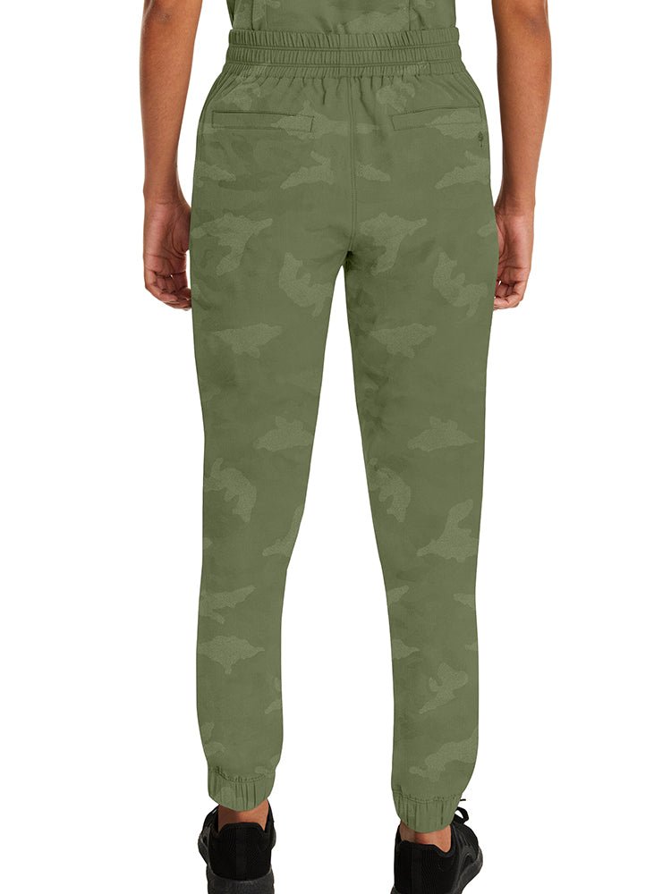 Young female healthcare worker wearing a pair of Purple Label Women's Tate Camo Joggers in Olive with an elasticized hemline.
