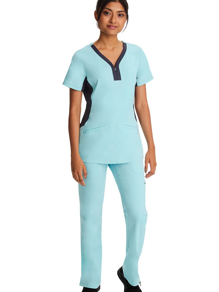 Female healthcare worker wearing a pair of Purple Label Women's Tori Yoga Scrub Pants in "Seabrook" featuring 2 back patch pockets with trim details.
