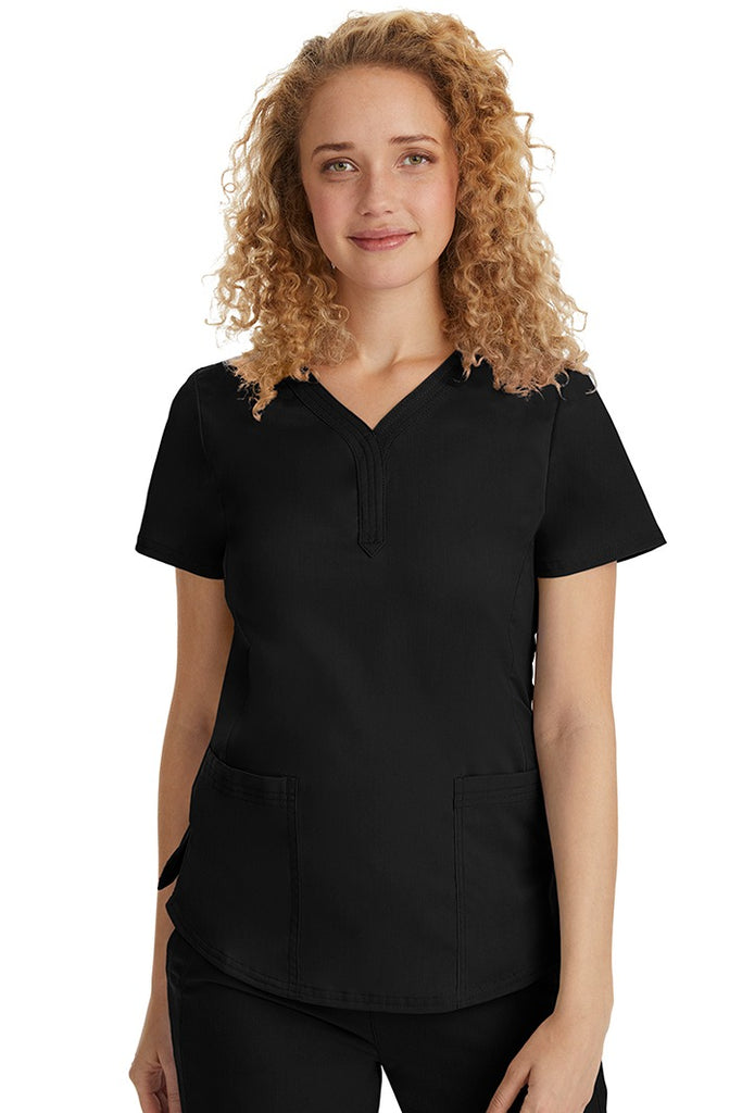 A female Emergency Room Registered Nurse wearing a Purple Label Women's Jane V-Neck Scrub Top in Black featuring front seams for a flattering a fit.