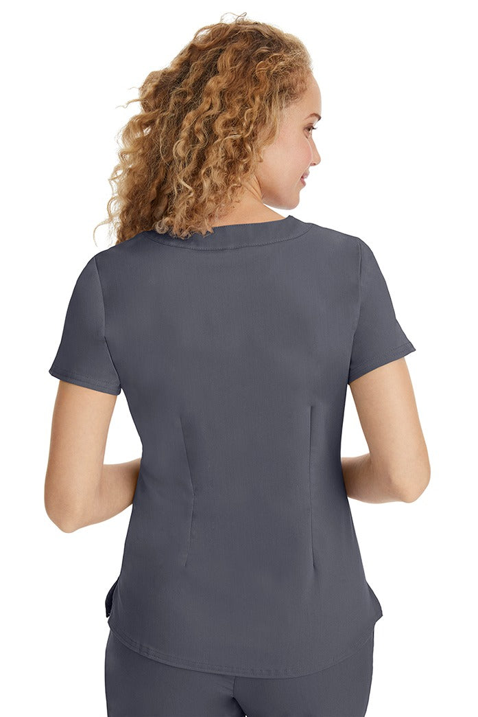 A young LPN wearing a Purple Label Women's Jane V-Neck Scrub Top in Pewter featuring a medium center back length of 26.5".