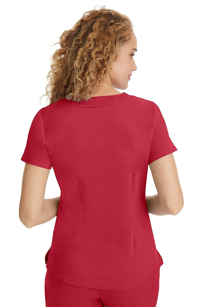 A young LPN wearing a Purple Label Women's Jane V-Neck Scrub Top in Red featuring a medium center back length of 26.5".