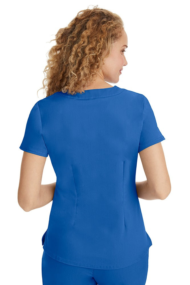A young LPN wearing a Purple Label Women's Jane V-Neck Scrub Top in Royal featuring a medium center back length of 26.5".